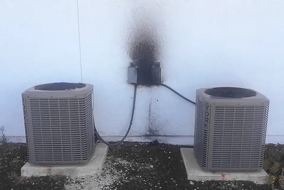 A pair of outdoor air conditioning units that were fried by a power surge.