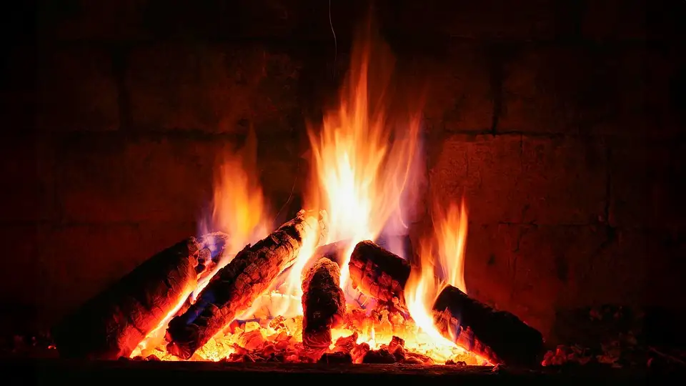 The warmth of a yule log fire radiates from the fireplace.